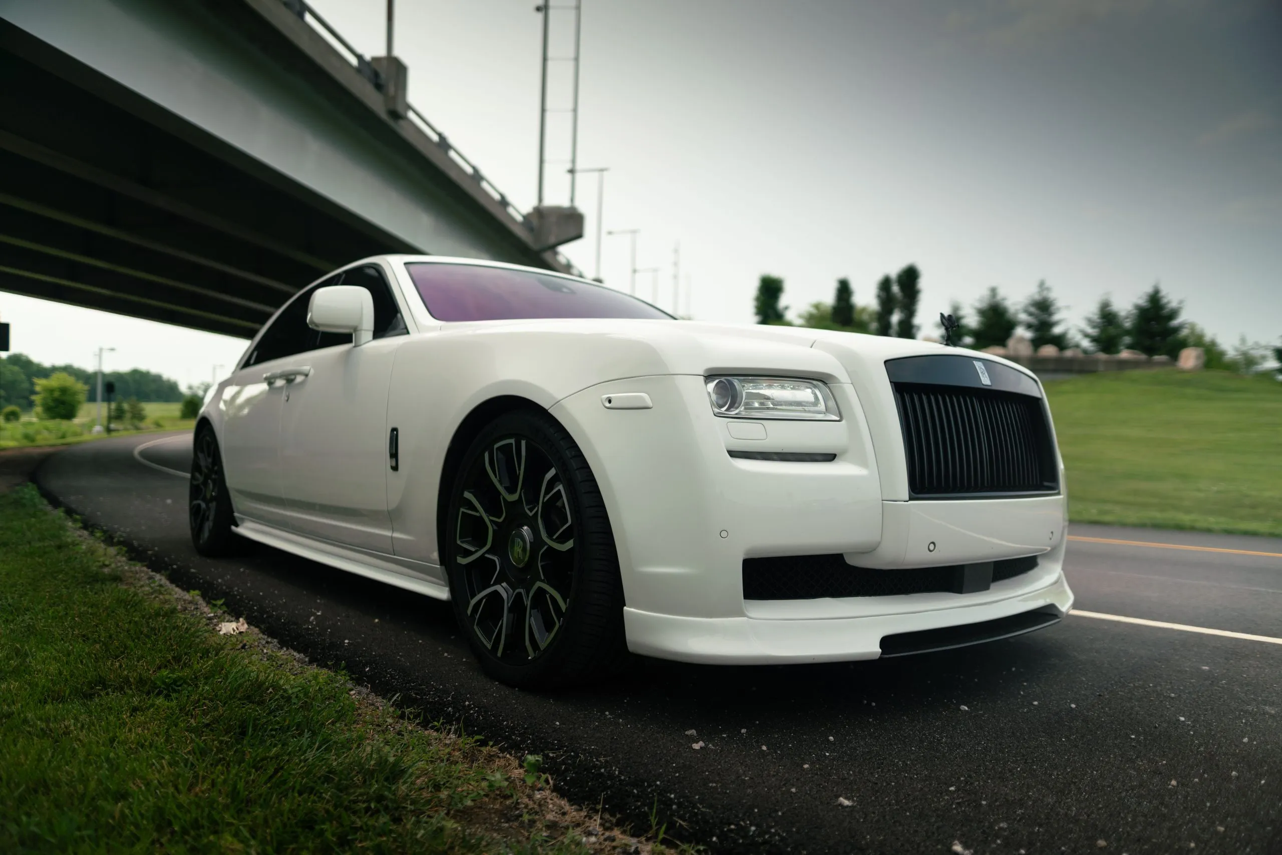 White Rolls-Royce Ghost parked beneath an overpass in Louisville